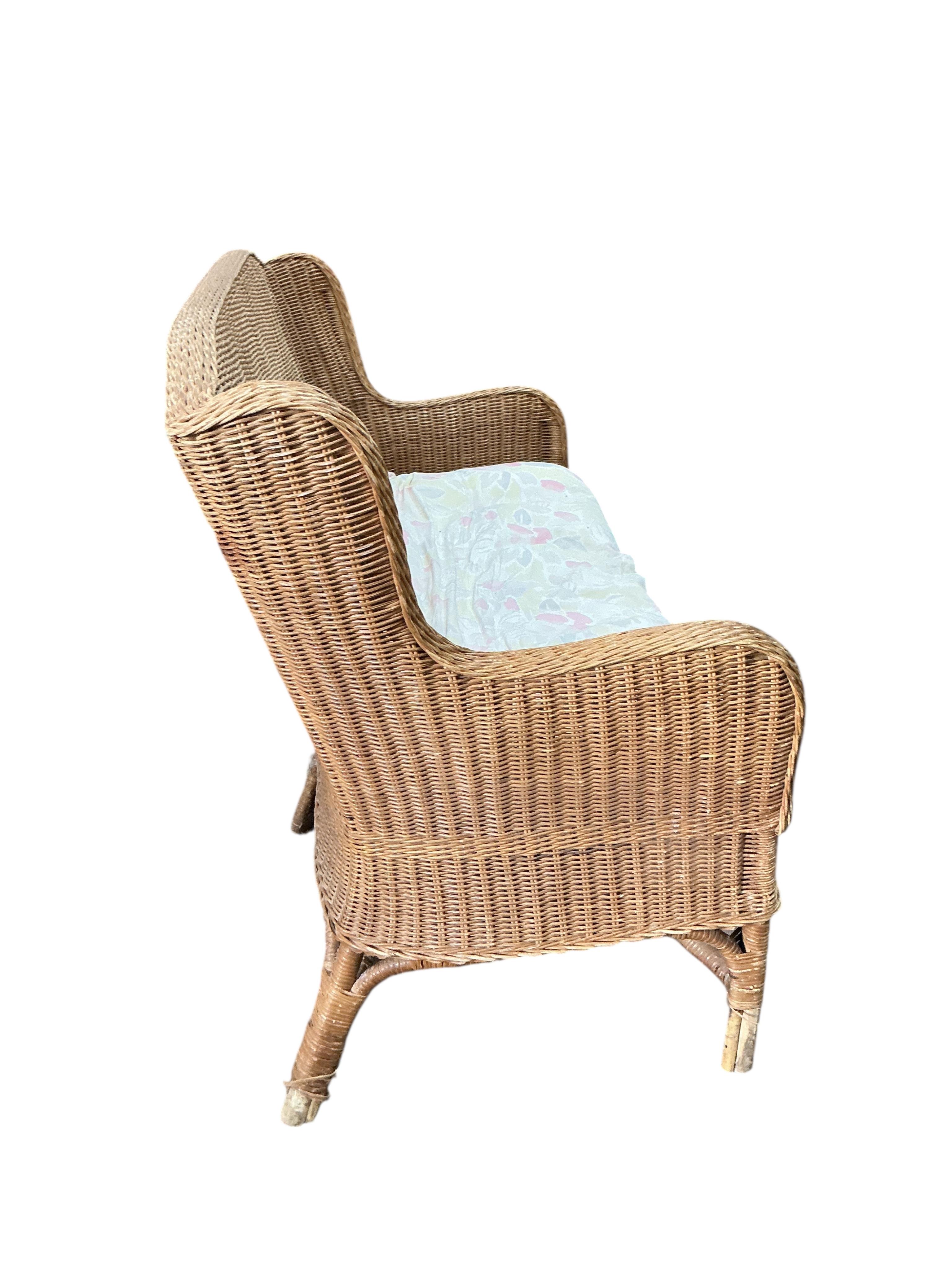 A cane conservatory settee, width 130cm, depth 66cm, height 90cm